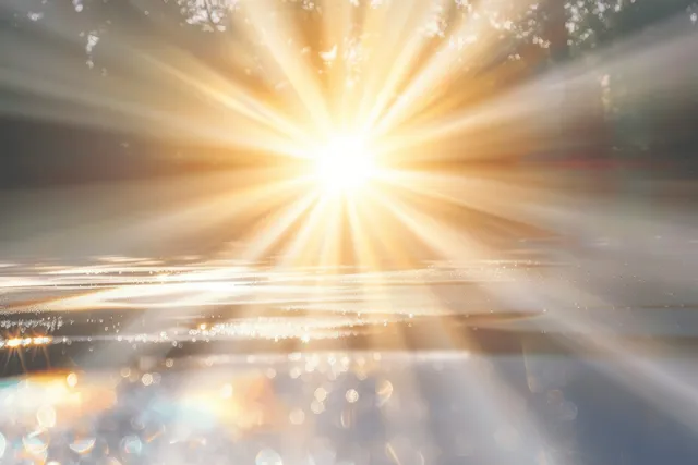 White light rays burst from a bright center over a hazy gradient with faint rainbow reflections.
