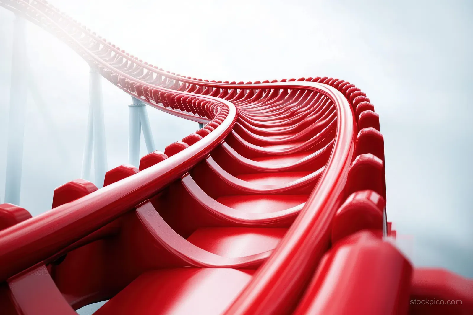 Bright red roller coaster track curves upward into a cloudy sky with detailed support structure visible.