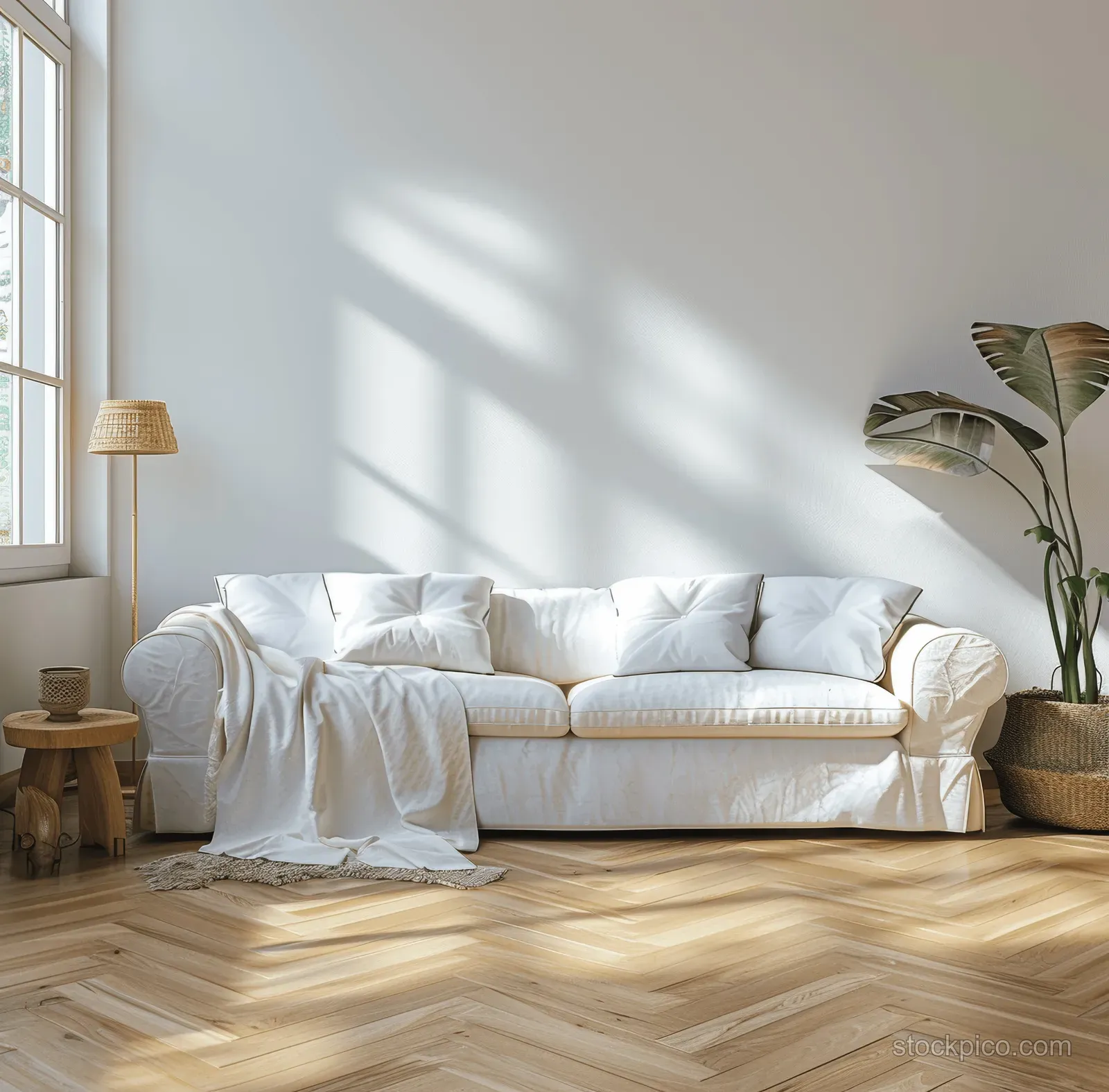 White sofa in a bright minimalist living room with sunlight shadows, wooden floor, and simple natural decor.