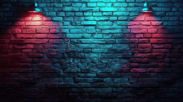 Dark exposed brick wall lit by red and blue spotlights, showing rough texture and glowing shadows.