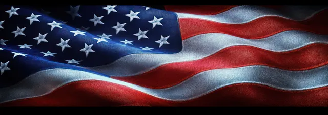 Close-up American flag rippling with visible stars and stripes under dramatic lighting.
