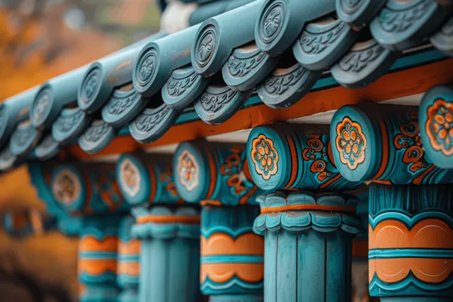 Painted teal and orange roof eaves with repeating floral medallion tiles and scalloped trim