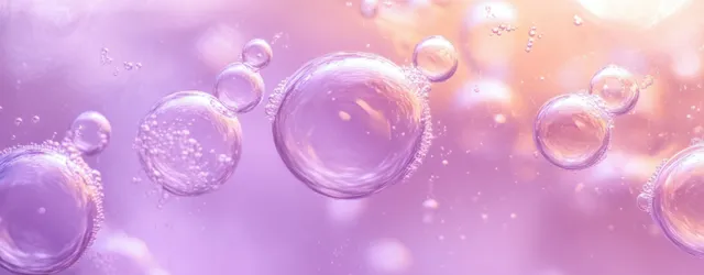 Transparent bubbles rise through a purple and pink glowing liquid, reflecting soft shimmering light.