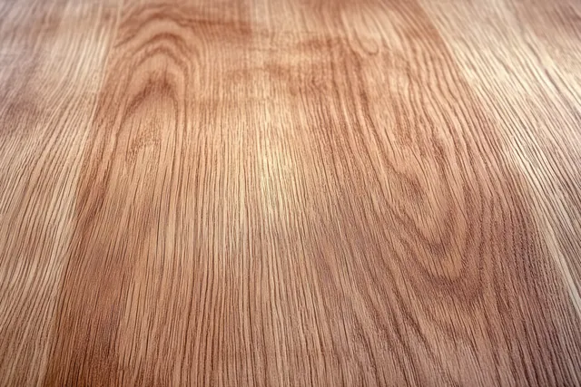 Macro close up of warm brown wood grain texture with smooth surface and fine fiber lines.