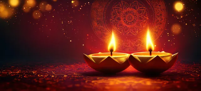 Two lit clay diyas glow against a dark background with a glowing mandala pattern and warm bokeh embers.