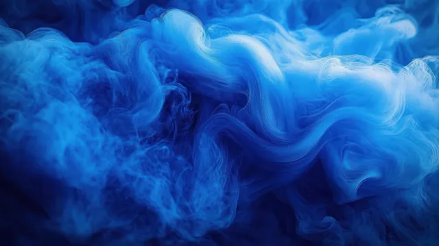Dense blue smoke billows over water, swirling into smooth wave-like abstract patterns.