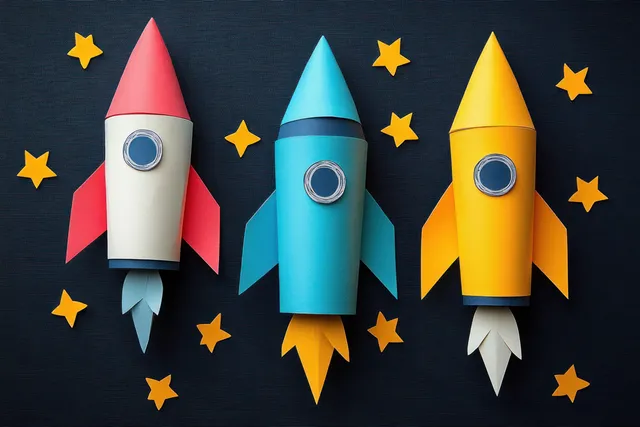 Three colorful paper rockets with star cutouts are arranged on a dark background.