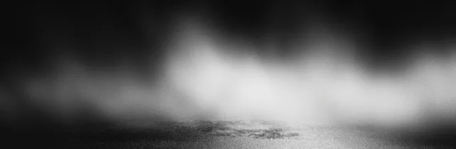 Grainy abstract gray gradient background with a subtle central light fog, suitable for modern design applications.