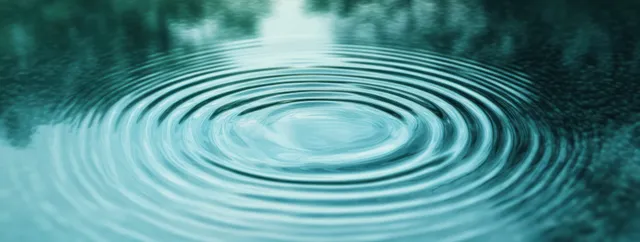 Teal water surface ripples forming concentric circles with soft pastel watercolor effect