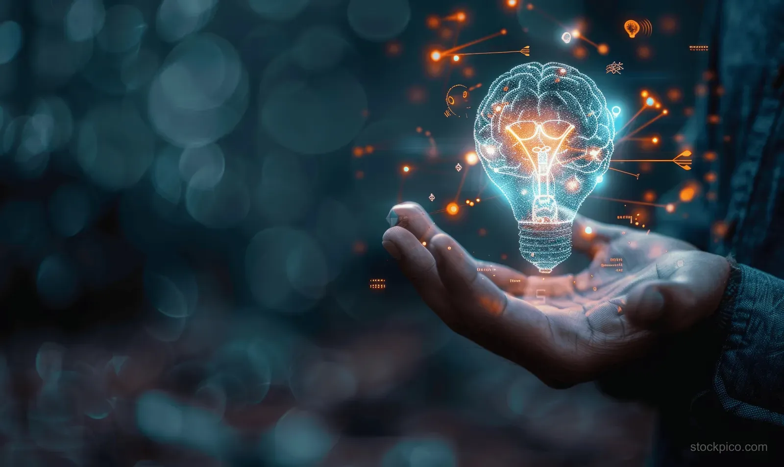 A businessman holds a glowing light bulb and a brain hologram with floating digital sparks over a dark bokeh background.