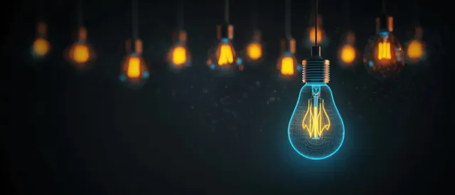 Hanging filament light bulbs in a dark room with one bulb surrounded by a blue wireframe glow.
