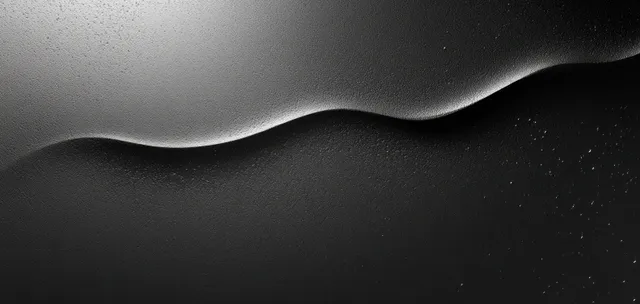 Monochrome black gradient texture with soft wave lighting and subtle grain background backdrop