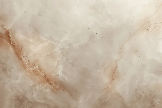 Cream beige marble texture background with faint brown veins and subtle speckled grunge on a flat surface.