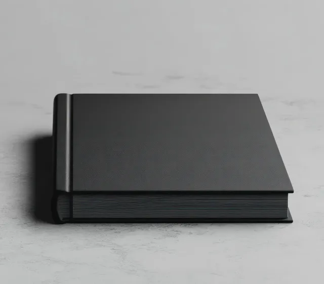 Matte black landscape notebook mockup on light concrete with soft side shadow