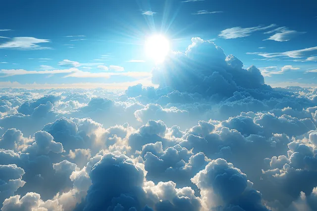 Bright sun glows above layered white clouds against a vivid blue sky from high altitude.