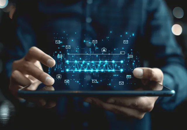 Hands holding a tablet that shows network security connection icons with a loading progress overlay.