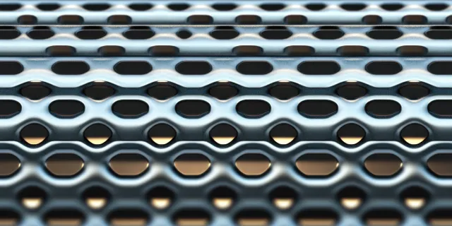 Close-up of perforated metal plate with oval holes forming a repeating geometric pattern