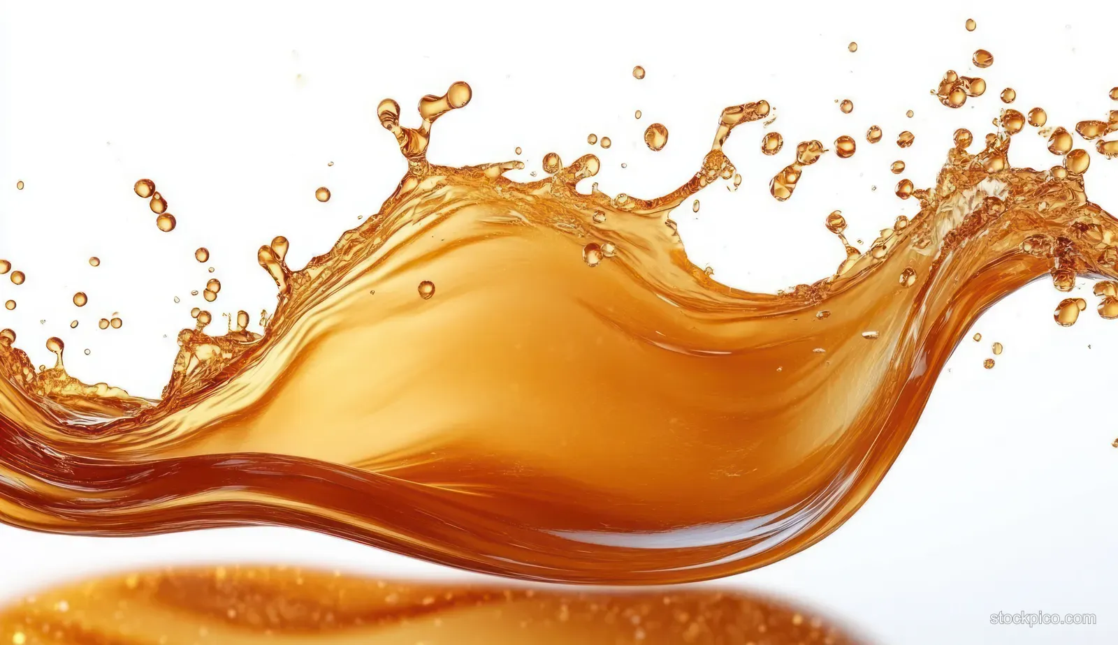 Amber liquid splash midair above a white background with droplets and flowing wave curves.