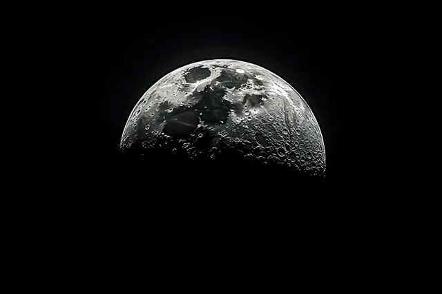 A bright full moon shows detailed craters and shadowed texture against a dark night sky.