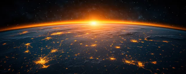 Earth viewed from above at night showing Europe’s glowing city lights along a curved horizon.