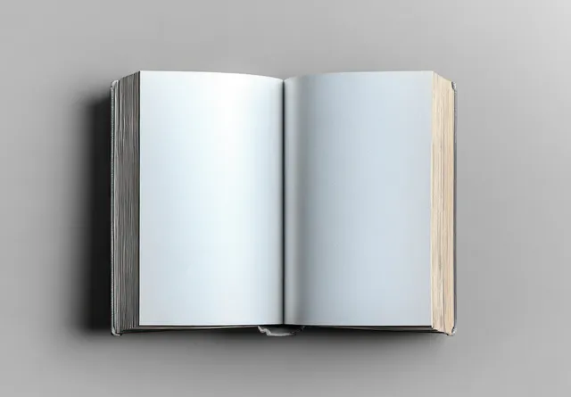 Minimal open book on gray background with blank pages and soft natural light
