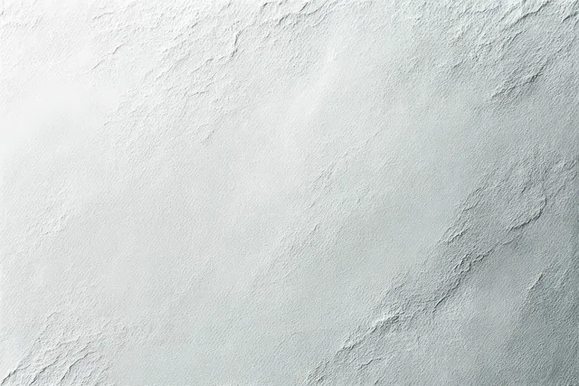 Light gray stucco wall close-up with rough uneven plaster texture and faint cracks.