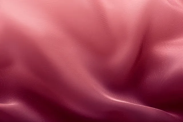 Maroon satin fabric background with pink gradient and gentle folded texture.