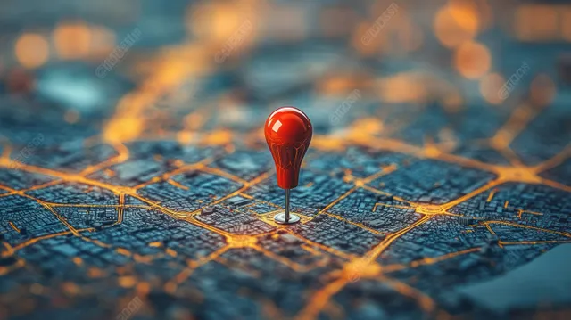 A red pushpin marks a city location on a map with visible street routes and warm bokeh lights.