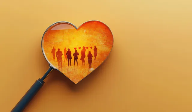 Magnifying glass reveals heart silhouettes and floating love shapes on orange background texture