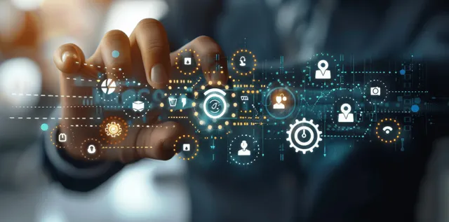 A person’s hand holds glowing digital icons over a blurred office background representing workplace well-being and engagement.