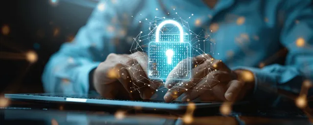 Businessman’s hands typing on laptop with floating digital padlock over network security icons