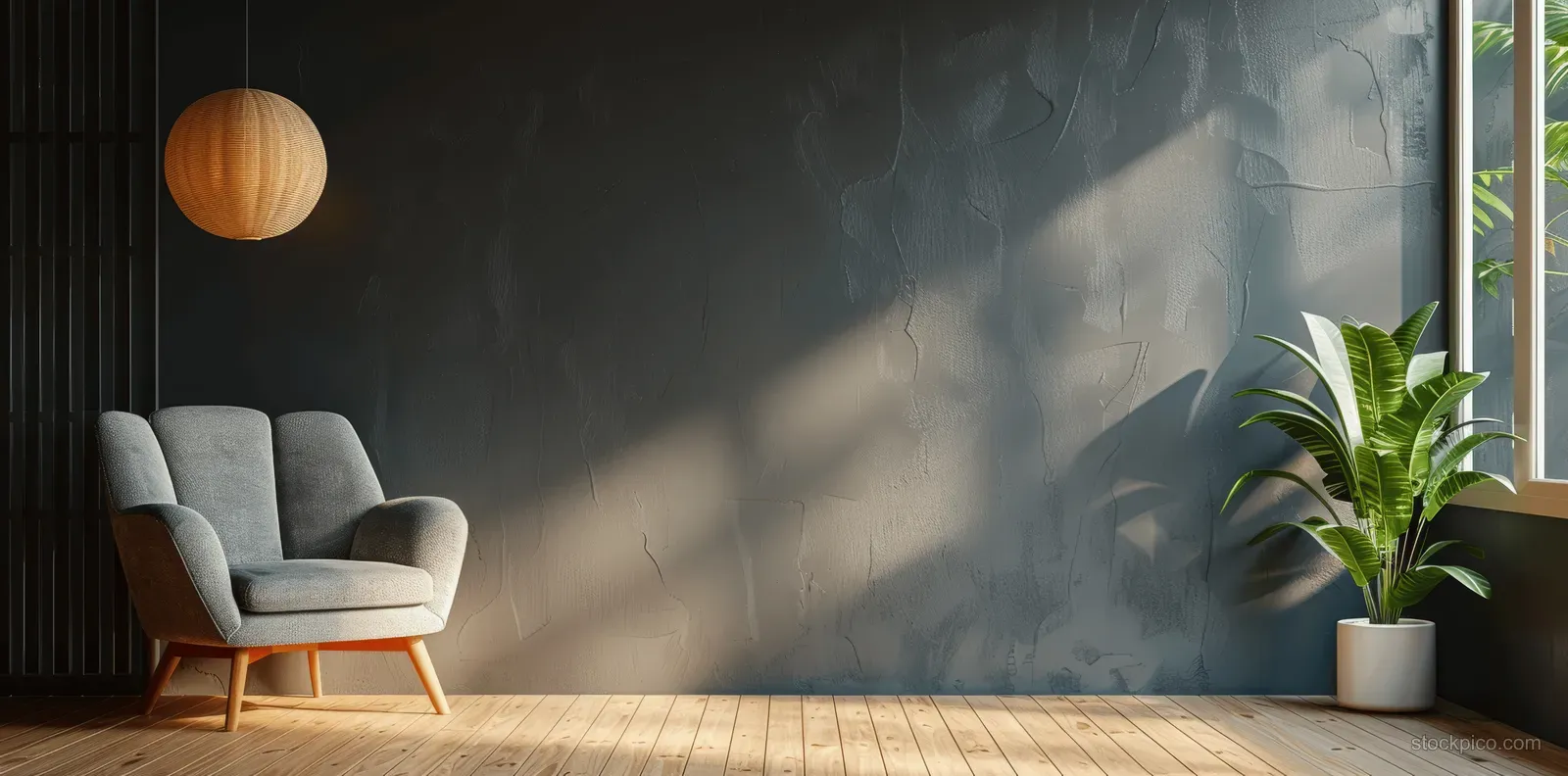 Leather armchair in a minimalist living room with dark gray wall, wood floor, and a potted plant by the window.