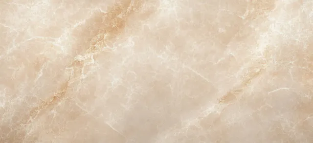 Beige marble wall texture with soft natural light and subtle veining details