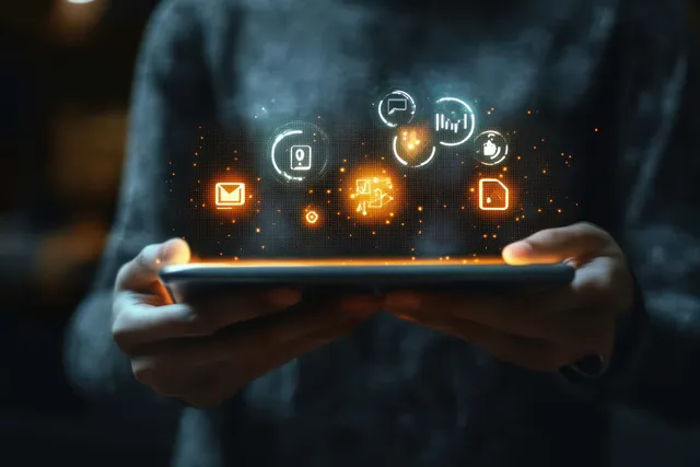 Businessman holds a tablet displaying glowing customer targeting and marketing CRM icons