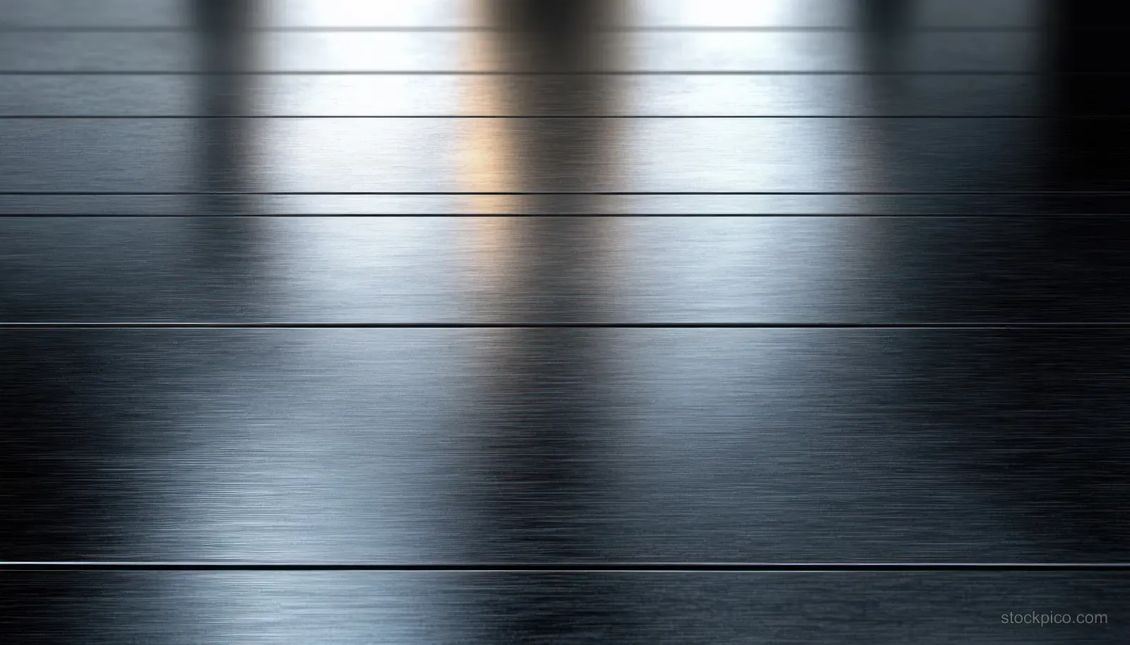 Brushed stainless steel panels with horizontal grain lines and soft reflective highlights.