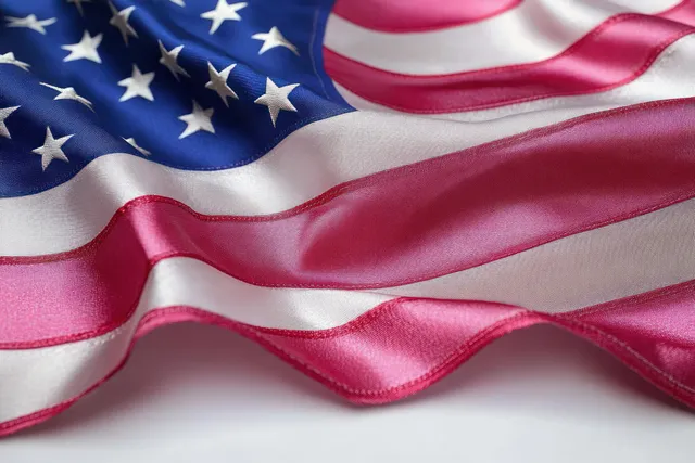 American flag close-up with rippling stars and stripes in soft light