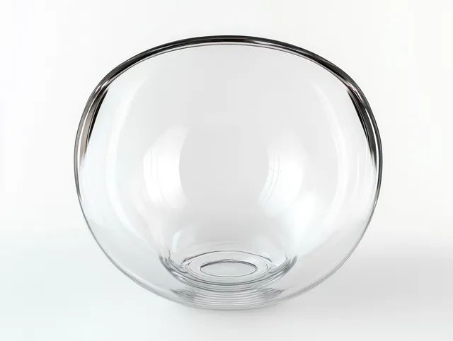 Clear round glass bowl on a white background with soft reflections and a smooth rim.