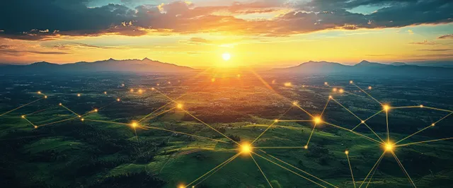 Sunset over green hills with glowing network nodes linked by light lines across distant valleys.