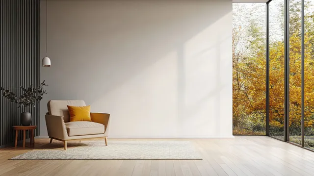 Beige armchair with yellow pillows on a patterned rug in a bright minimalist living room by large windows.