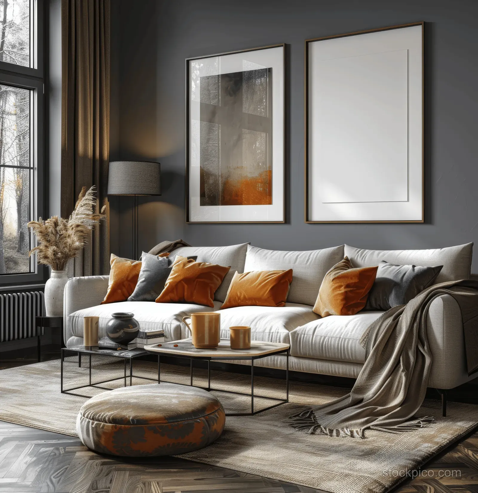 A modern living room with dark gray walls, a beige sofa, and two blank poster frames above the couch.