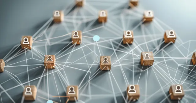 Human icon figures connected by light network lines surround a central red target board on a blue background.