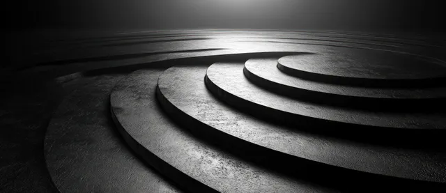 Grayscale concentric curved rings swirl into a textured vortex under soft spotlight lighting.