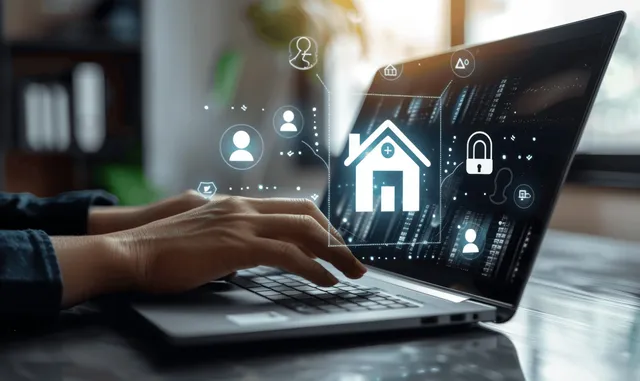 A person types on a laptop with a glowing digital home icon and property finance icons displayed.