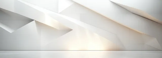 Minimalist white wall with angular geometric recesses and gentle light creating soft shadows.