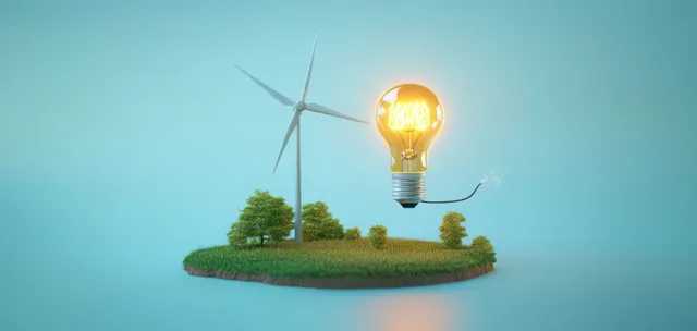 Wind turbine and glowing light bulb over grassy island with trees for clean power concept