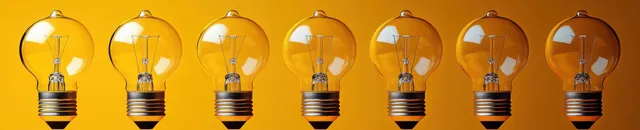 A row of glowing light bulbs on a yellow background with one brighter bulb in focus.