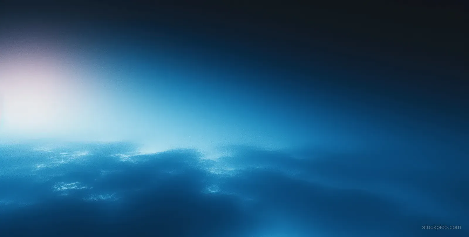 Blue and black abstract gradient background with a soft glowing light spot and subtle textured blur.