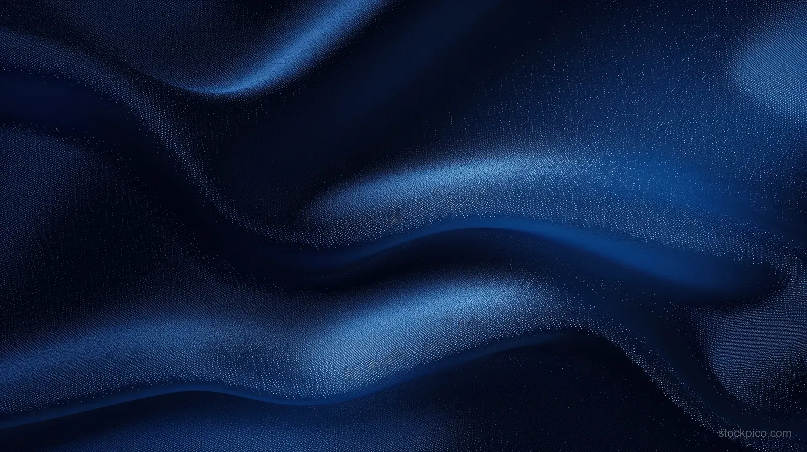 Dark blue satin fabric with smooth wavy folds and shimmering highlights across the cloth surface.