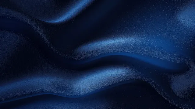 Dark blue satin fabric with smooth wavy folds and shimmering highlights