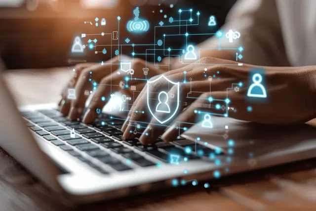Hands typing on a laptop with floating lock and user security icons over glowing network connections.